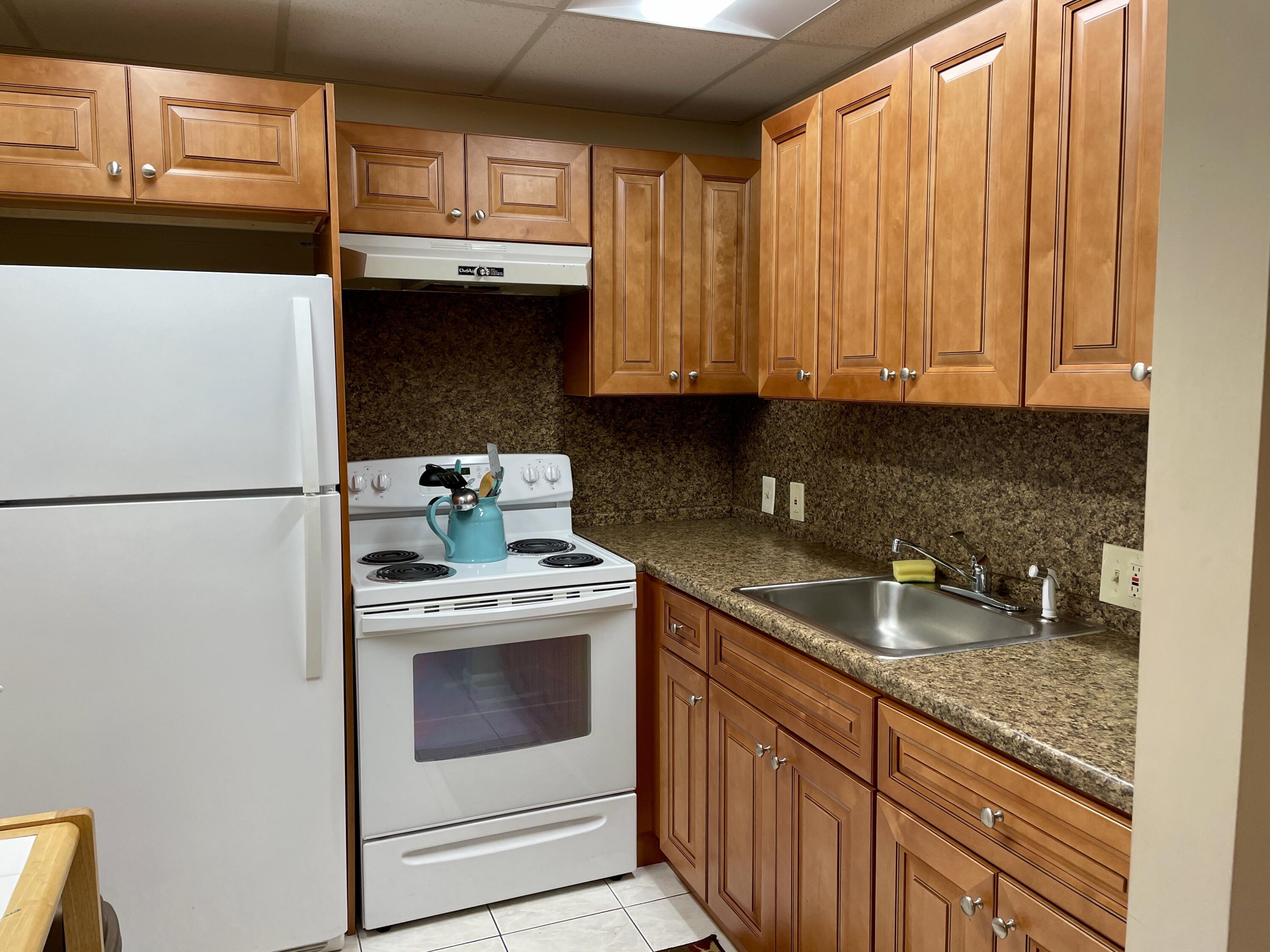 296 Preston H Boca Raton, FL 33434 - Photo 9 of 21 a kitchen with granite countertop cabinets stainless steel appliances and a sink