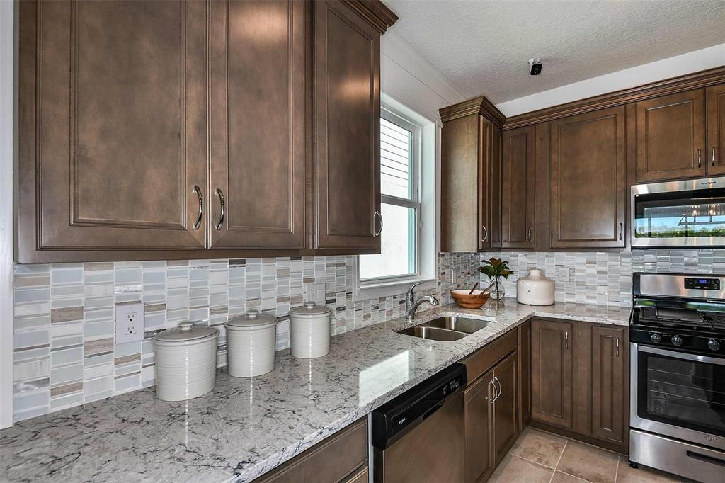 2362 Daisy Tree Road St. Cloud, FL 34771 - Photo 5 of 31 a kitchen with a sink stove and cabinets