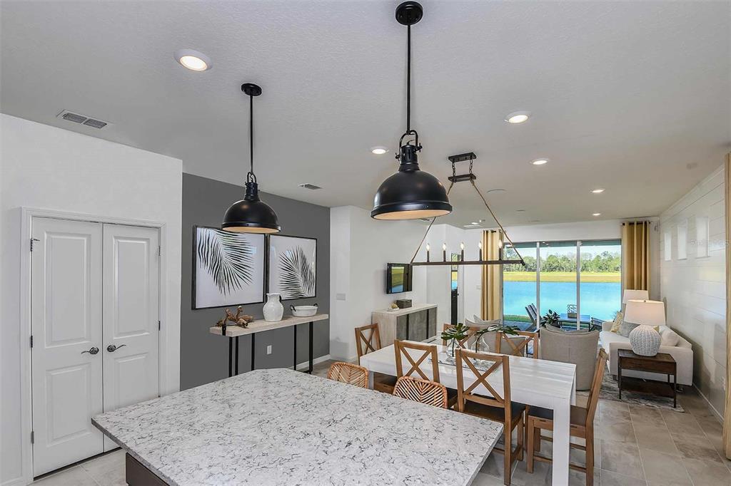 2362 Daisy Tree Road St. Cloud, FL 34771 - Photo 10 of 31 a kitchen with stainless steel appliances granite countertop table chairs and a wooden floor