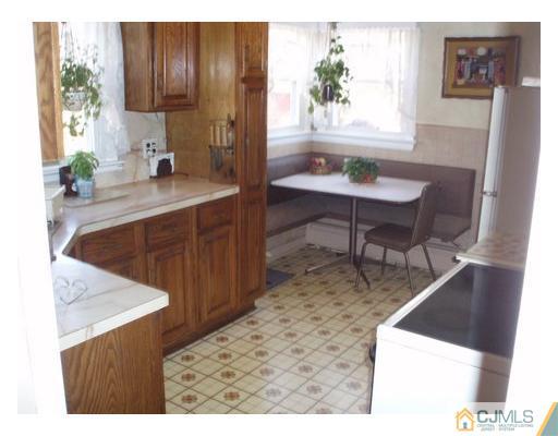 125 Clyde Road Somerset, NJ 08873 - Photo 12 of 13 a kitchen with a sink cabinets and wooden floor