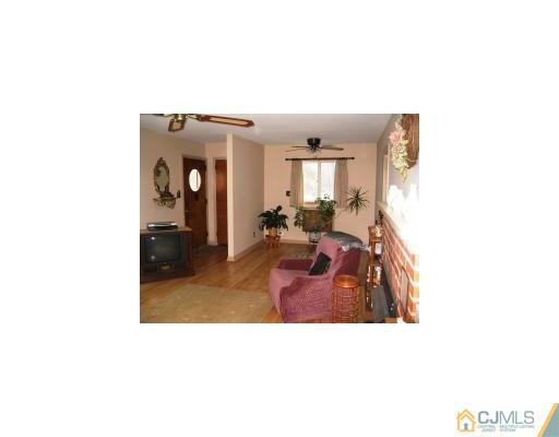 125 Clyde Road Somerset, NJ 08873 - Photo 4 of 13 a living room with furniture and a mirror