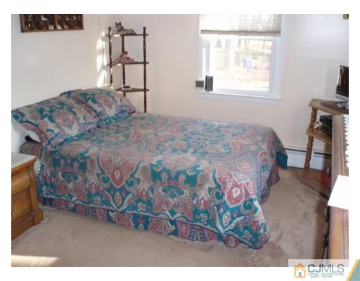 125 Clyde Road Somerset, NJ 08873 - Photo 6 of 13 a bedroom with a bed window and a flat screen tv