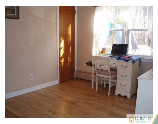 125 Clyde Road Somerset, NJ 08873 - Photo 7 of 13 a living room with furniture a flat screen tv and a window