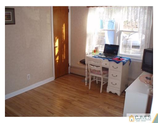 125 Clyde Road Somerset, NJ 08873 - Photo 8 of 13 a view of a workspace with furniture and a window