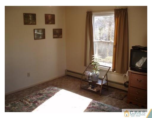 125 Clyde Road Somerset, NJ 08873 - Photo 9 of 13 a room with furniture and a window