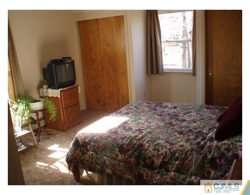 125 Clyde Road Somerset, NJ 08873 - Photo 10 of 13 a bedroom with a bed and a window