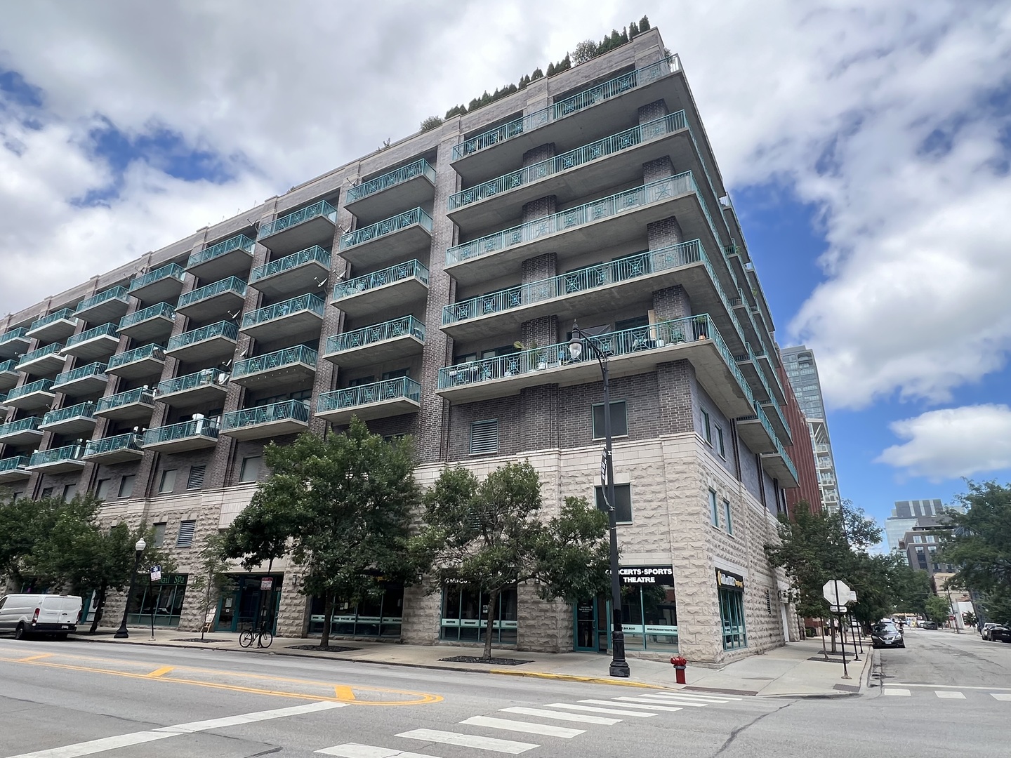 a view of a tall building next to a road