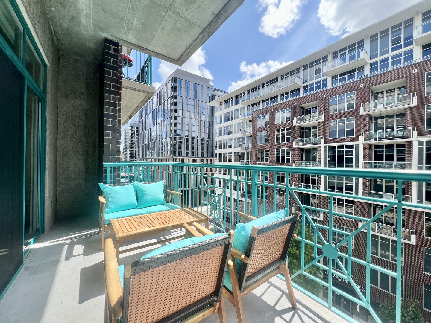 910 West Madison Street, Unit 602 Chicago, IL 60607 - Photo 13 of 14 a view of a building from a chairs and table in the balcony