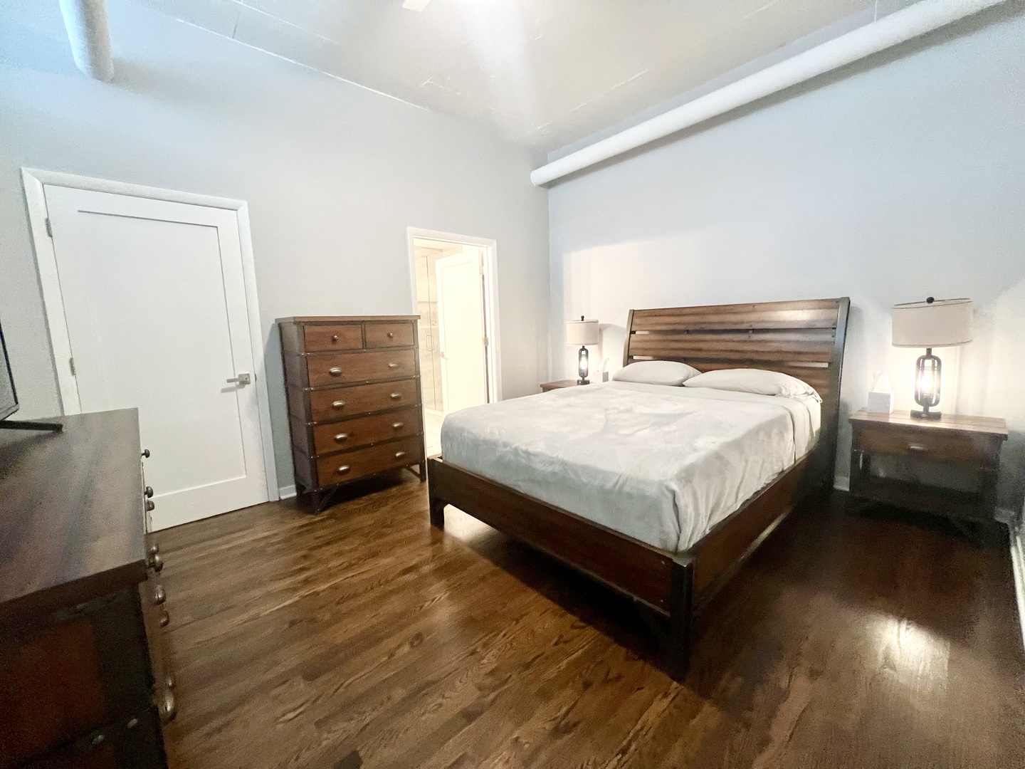 910 West Madison Street, Unit 602 Chicago, IL 60607 - Photo 6 of 14 a bedroom with a bed and a dresser