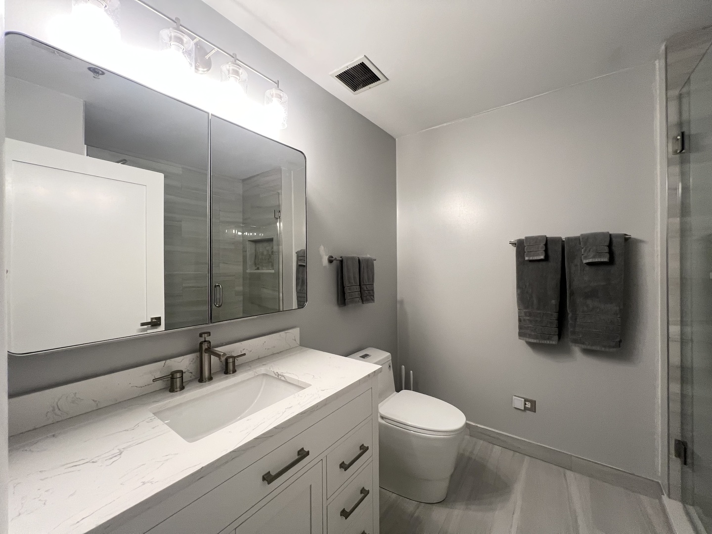 910 West Madison Street, Unit 602 Chicago, IL 60607 - Photo 7 of 14 a bathroom with a toilet sink and mirror