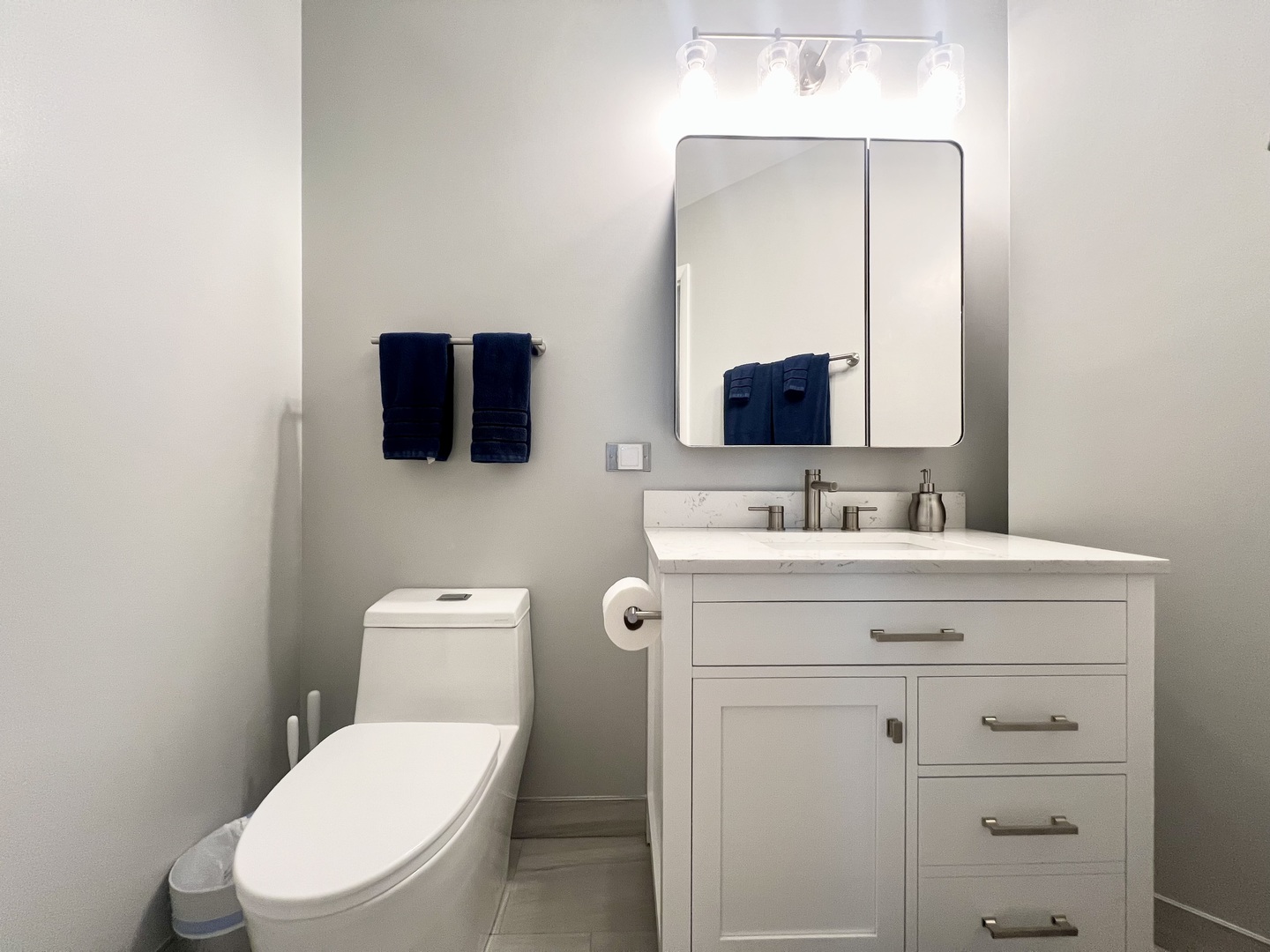 910 West Madison Street, Unit 602 Chicago, IL 60607 - Photo 10 of 14 a bathroom with a toilet a sink a mirror and vanity