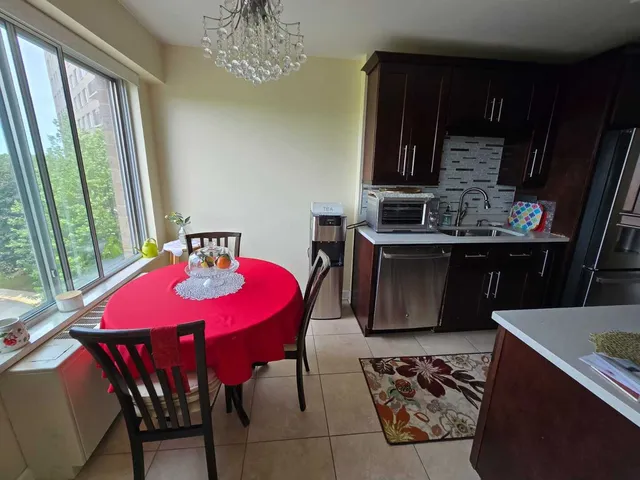 a kitchen that has a lot of cabinets and wooden floor