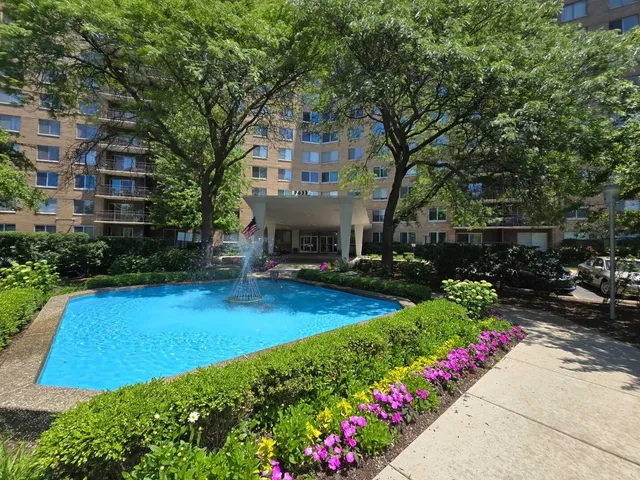 a view of a house with a yard and garden