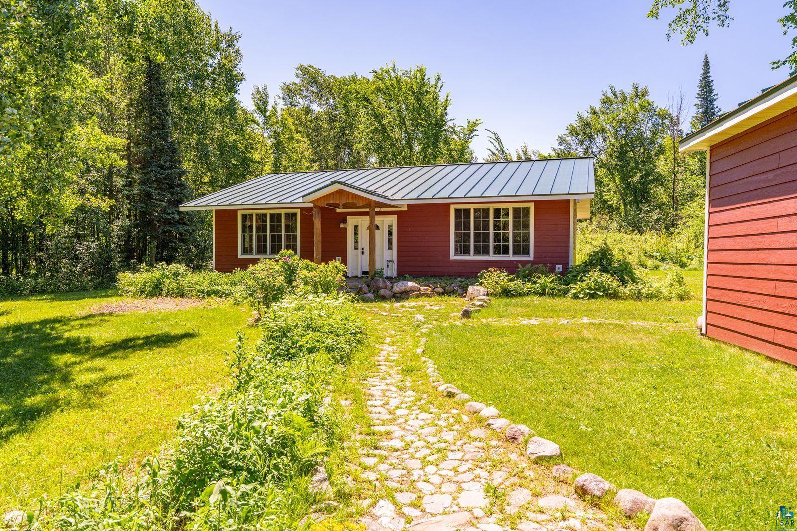 9734 Alango Road Angora, MN 55703 - Photo 1 of 41 Red exterior siding with white trim, featuring a light grey metal roof