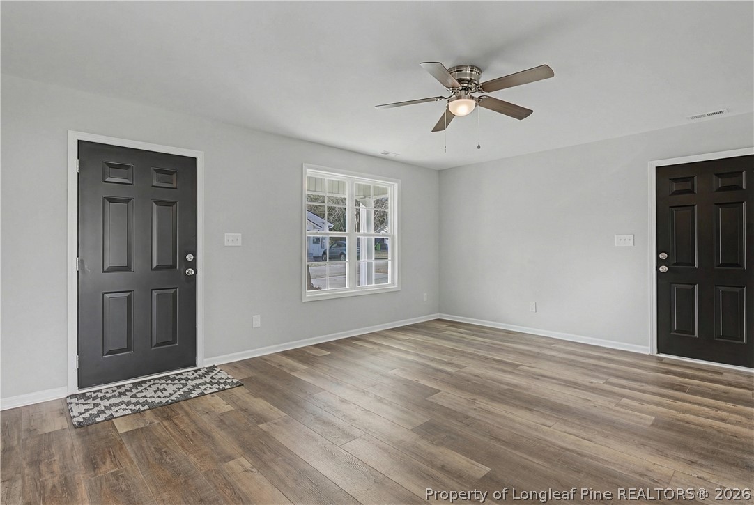 214 Lee Street Spring Lake, NC 28390 - Photo 11 of 44 a view of an empty room with a window and wooden floor