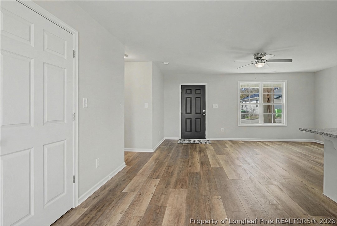 214 Lee Street Spring Lake, NC 28390 - Photo 18 of 44 a view of an empty room with wooden floor and a window