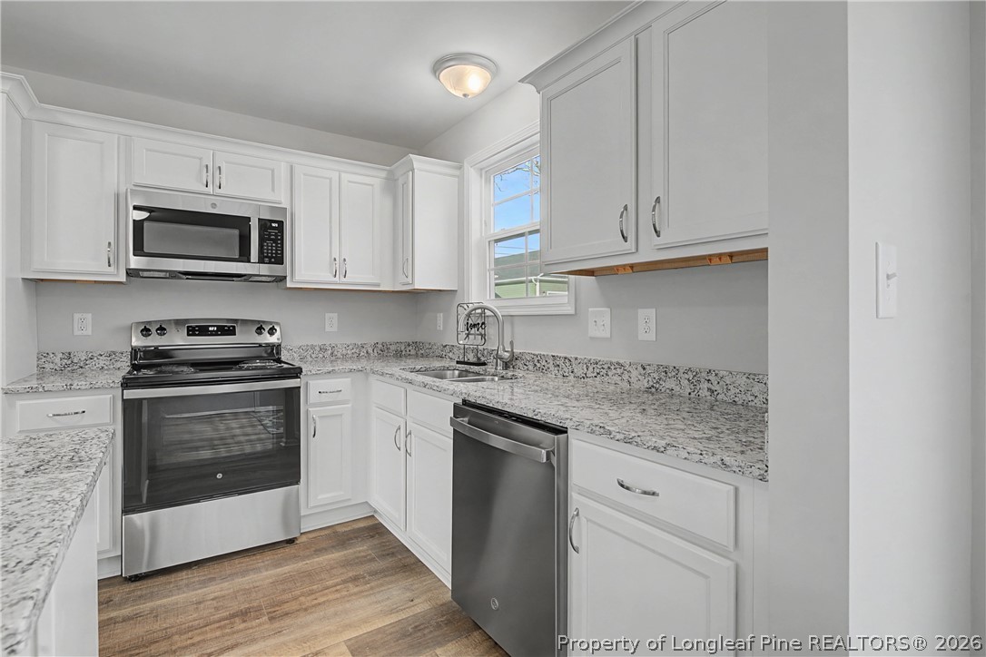 214 Lee Street Spring Lake, NC 28390 - Photo 20 of 44 a kitchen with stainless steel appliances granite countertop a stove and a sink