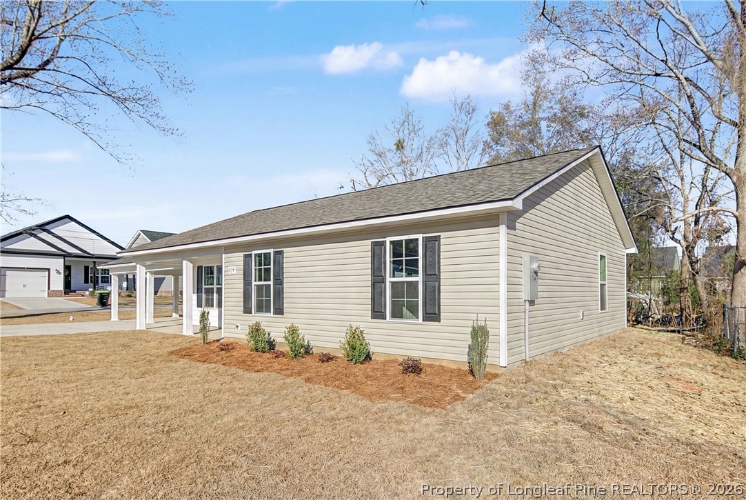 214 Lee Street Spring Lake, NC 28390 - Photo 2 of 44 a front view of a house with a yard and garage