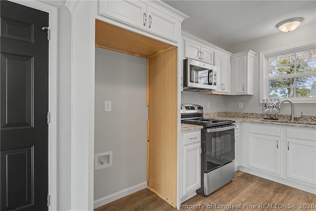 214 Lee Street Spring Lake, NC 28390 - Photo 22 of 44 a kitchen with stainless steel appliances granite countertop a stove a sink and a refrigerator