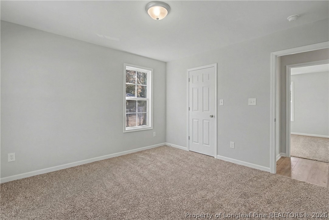 214 Lee Street Spring Lake, NC 28390 - Photo 26 of 44 an empty room with windows and closet