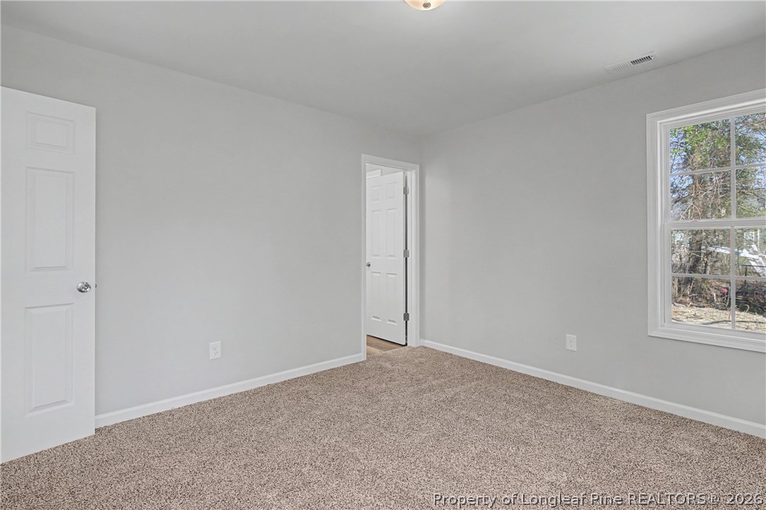 214 Lee Street Spring Lake, NC 28390 - Photo 28 of 44 an empty room with windows and closet