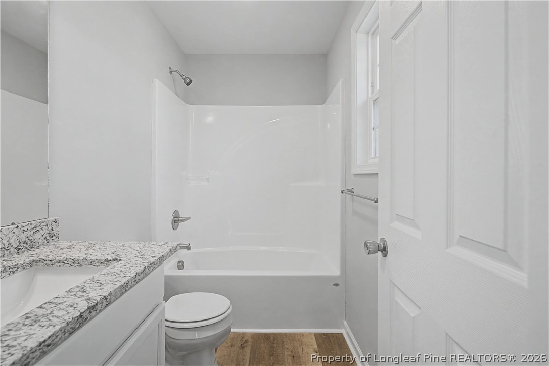 214 Lee Street Spring Lake, NC 28390 - Photo 29 of 44 a bathroom with a granite countertop sink toilet and shower