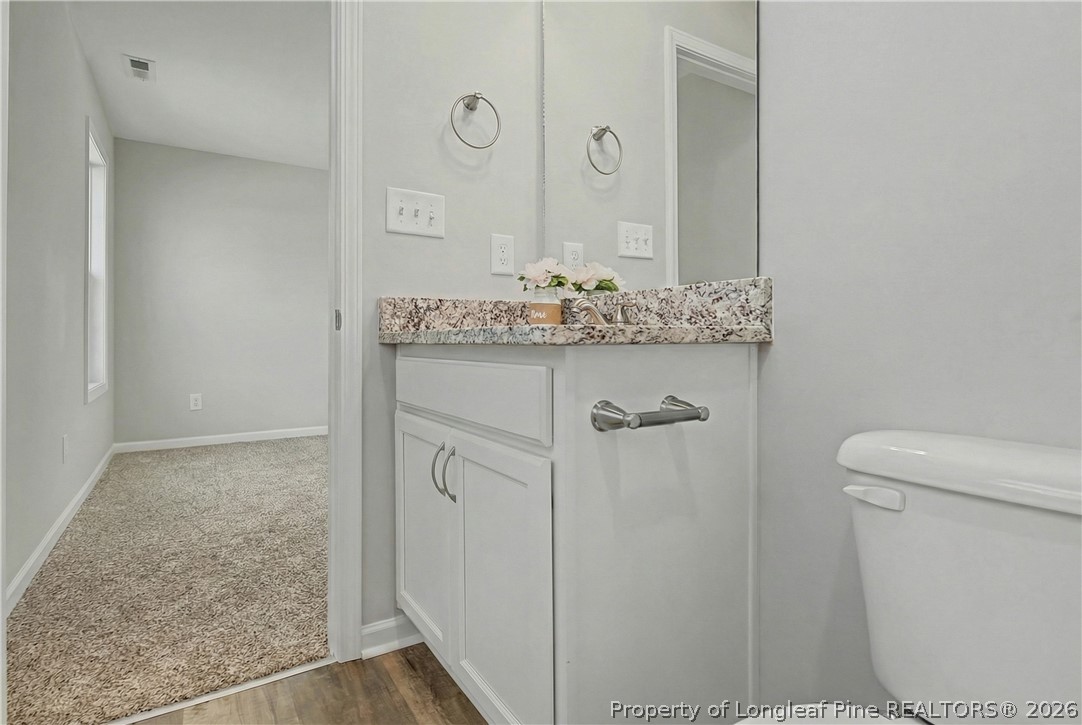214 Lee Street Spring Lake, NC 28390 - Photo 30 of 44 a bathroom with a granite countertop sink and a mirror