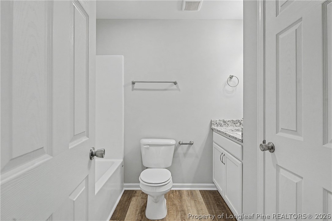 214 Lee Street Spring Lake, NC 28390 - Photo 35 of 44 a white toilet sitting next to a shower curtain