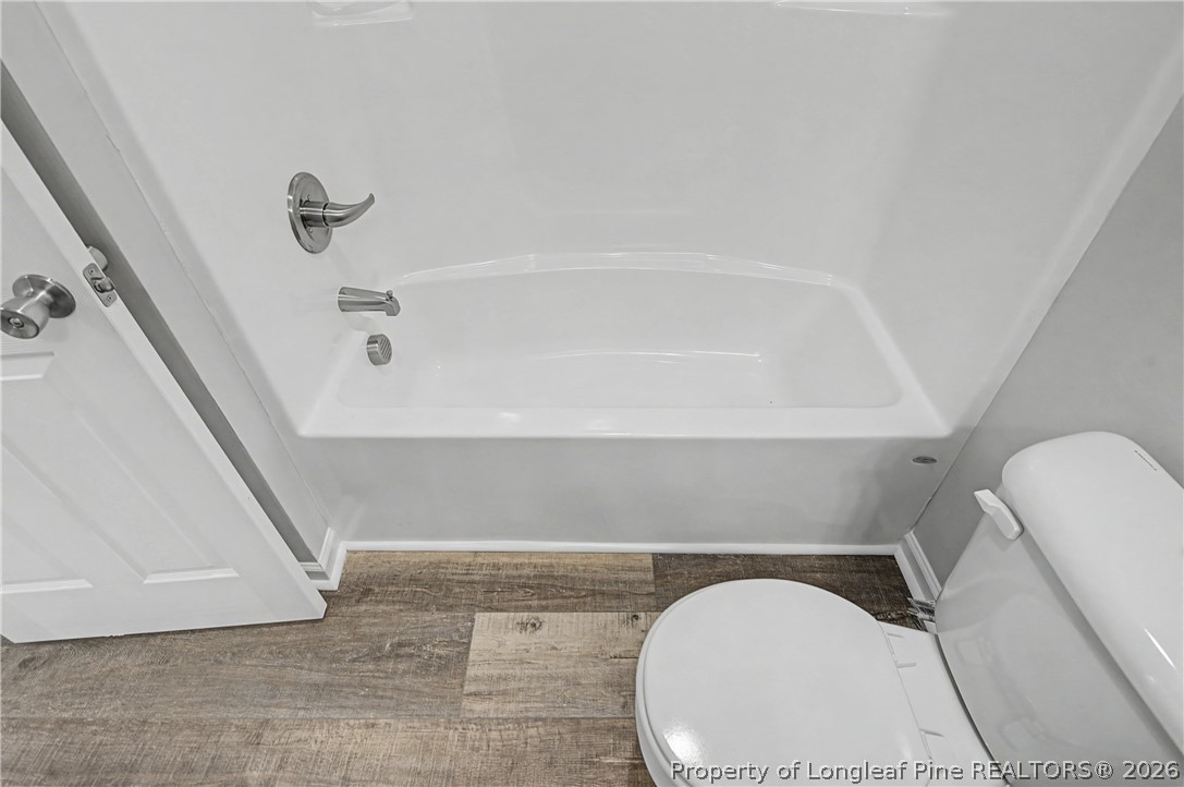 214 Lee Street Spring Lake, NC 28390 - Photo 37 of 44 a bathroom with a toilet and a bathtub