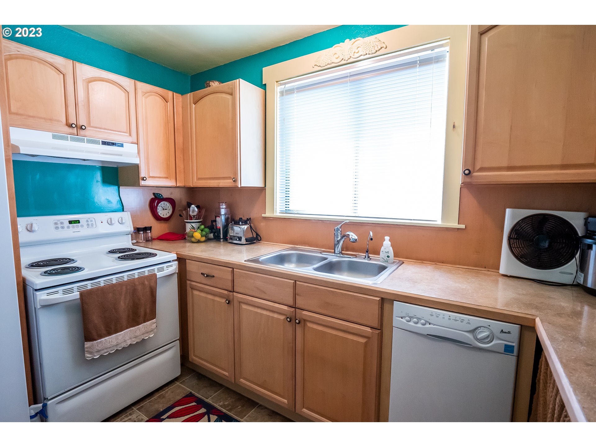 18624 Highway 36 Blachly, OR 97412 - Photo 24 of 46 a kitchen with a sink a stove and cabinets