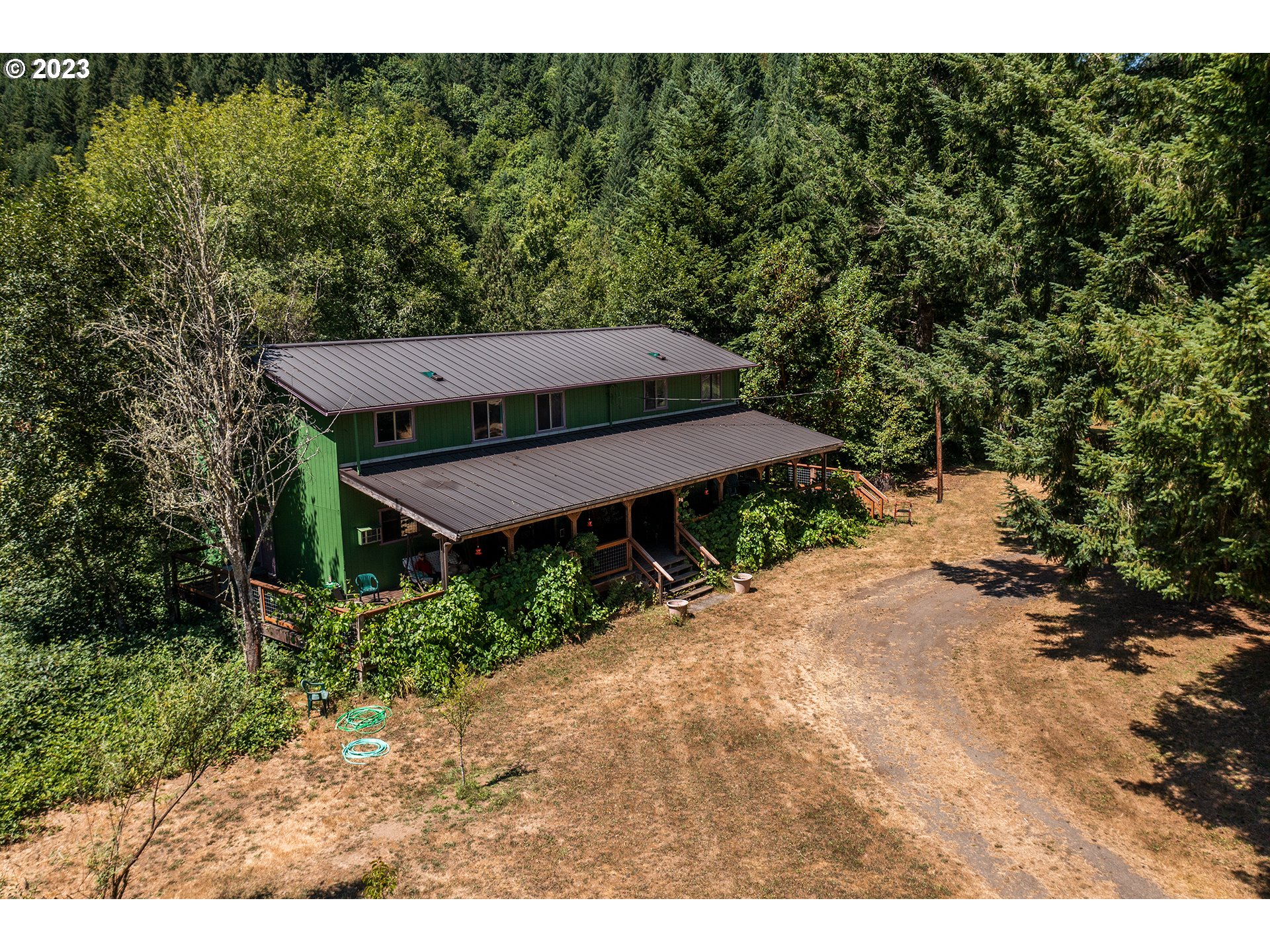 18624 Highway 36 Blachly, OR 97412 - Photo 3 of 46 a view of a backyard with potted plants and large tree