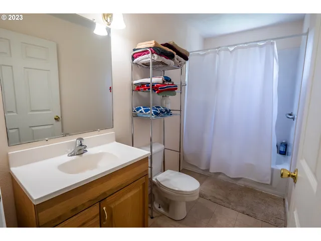 a room with a bed and wooden floor