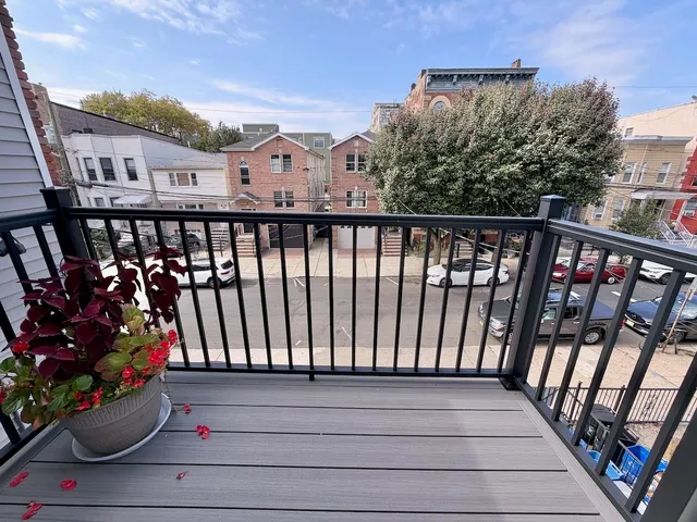 a view of a balcony with flower plants