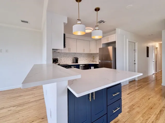 a kitchen with a sink a counter space and stainless steel appliances