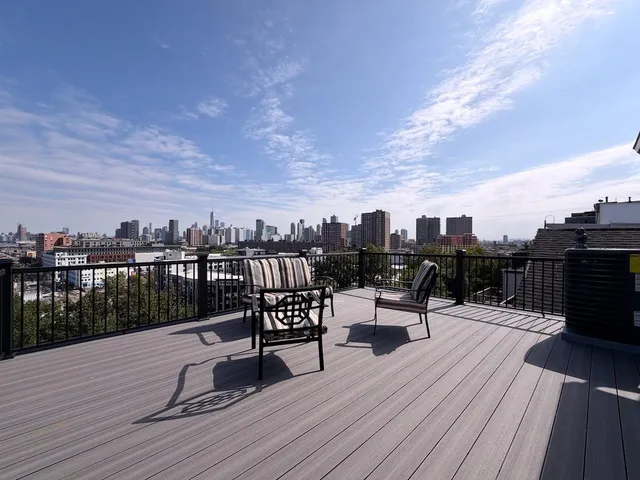 a view of a terrace with wooden benches