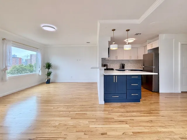 a kitchen with stainless steel appliances granite countertop a stove and a refrigerator