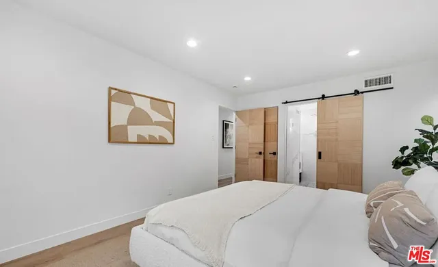 a bathroom with a bathtub a mirror a sink and vanity