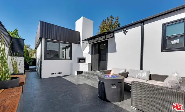 a kitchen with a sink stainless steel appliances a counter top space and cabinets