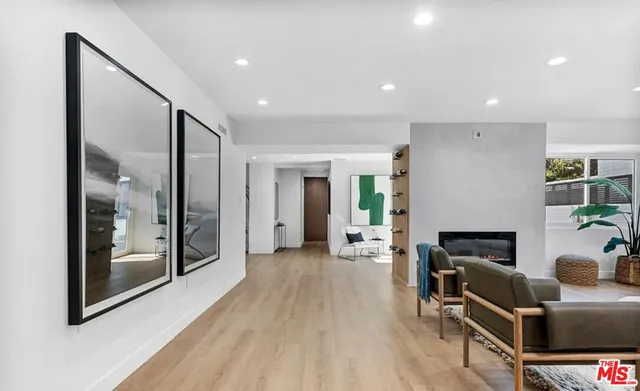a bedroom with a large bed and a potted plant