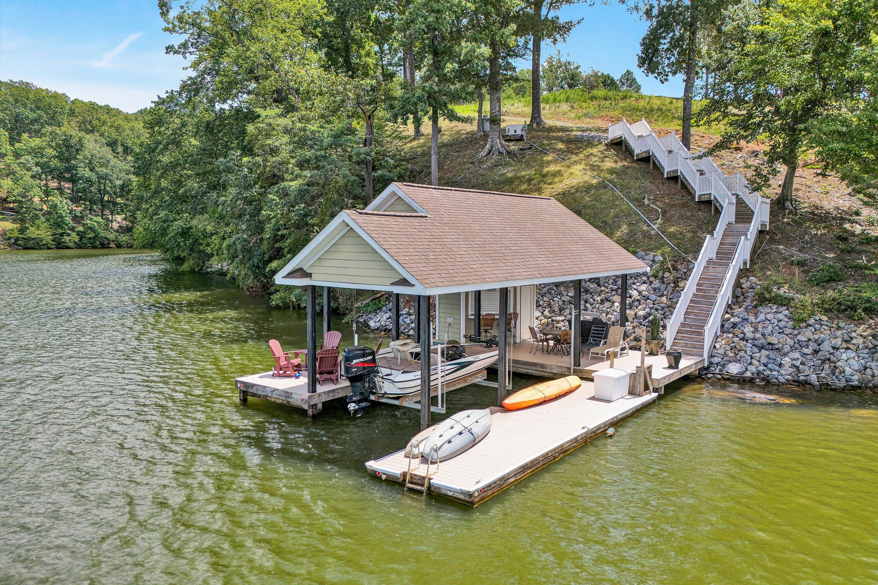 an aerial view of a house with swimming pool garden view and lake view