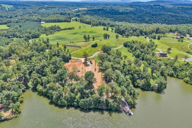 an aerial view of a houses with a lake view
