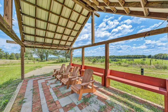 a view of swimming pool with a table and chairs in patio