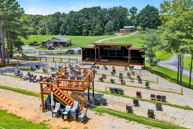 an outdoor space with seating area and trees around
