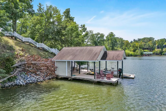 a view of a swimming pool with lawn chairs under an umbrella