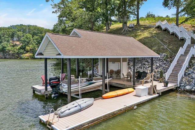 a view of a house with swimming pool and sitting area