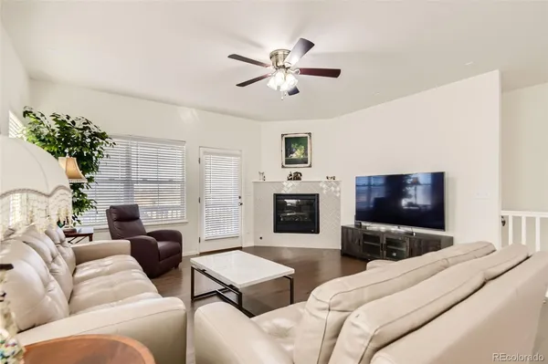 a living room with furniture a fireplace and a flat screen tv