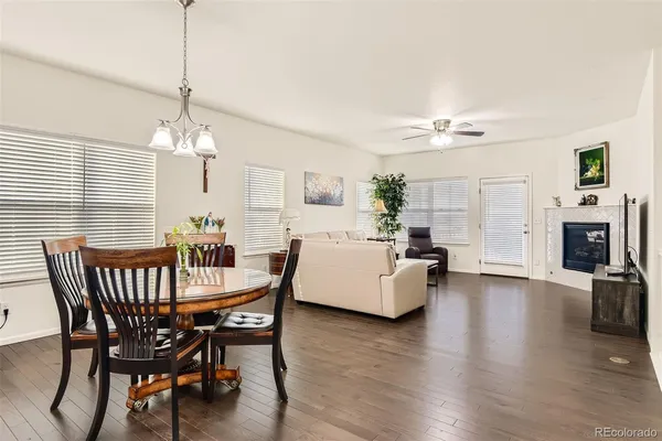 a view of a dining room with furniture wooden floor and chandelier
