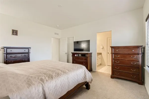a bedroom with a bed and a television