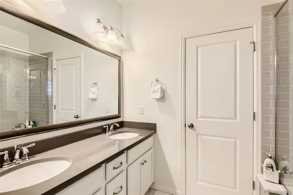 a bathroom with a double vanity sink and a mirror