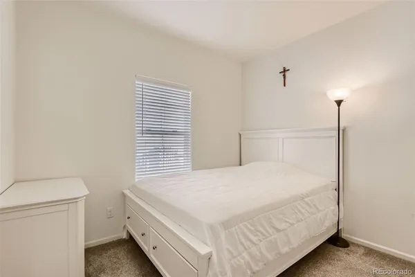 a bedroom with a bed and a night stand